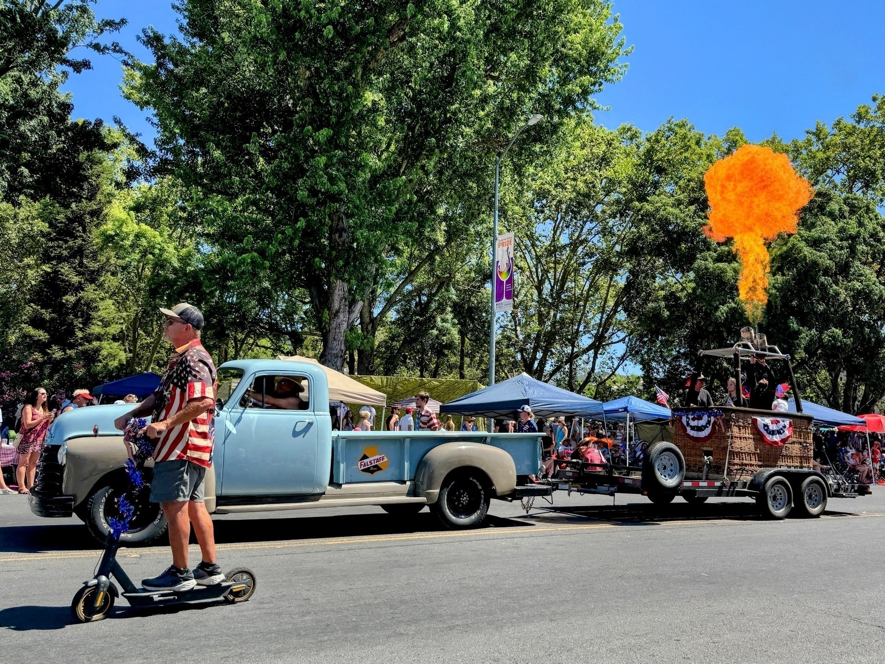Antique truck pulling a hot air balloon basket blowing fire in the Sonoma July 4th parade